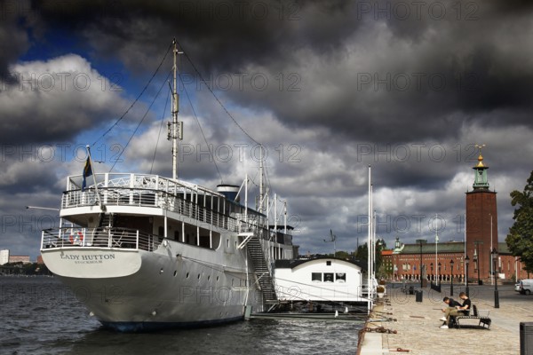 Stockholm City Hall on Kungsholmen with adjacent harbor and dramatic sky, Stockholm, Kungsholmen, Sweden