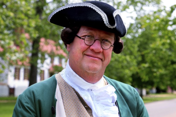Man in authentic colonial clothing smiling relaxed at camera, friendly portrait, Williamsburg, Virginia, USA