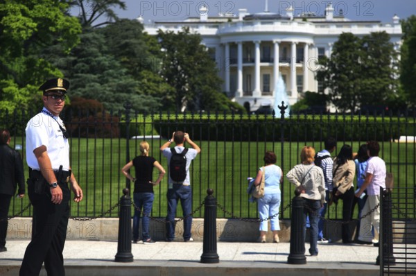 Visitors view the White House from a public area, Washington D.C, USA