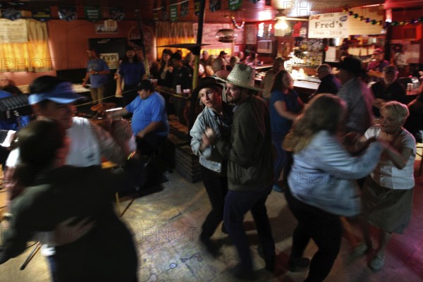 People dancing in Fred's Lounge with cozy atmosphere in Mamou, Mamou, Louisiana, USA