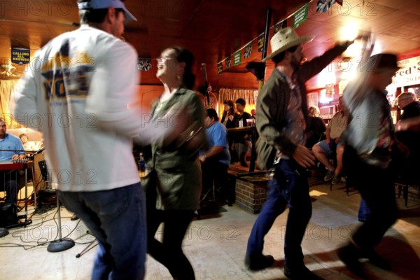 Couple dancing with energy in Fred's Lounge, Mamou, Louisiana, USA
