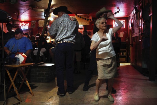 An elderly dancer dances in Fred's Lounge, Mamou, Louisiana, USA