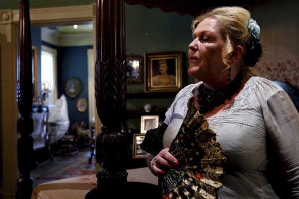 Woman with traditional fan in stylish room at Houmas House, Houmas House, Louisiana, USA