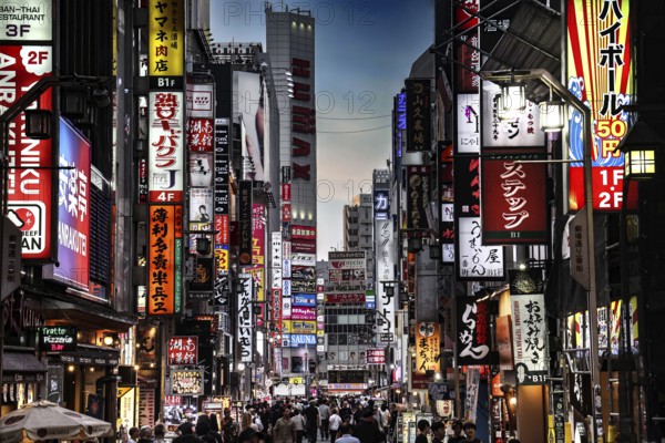Busy street in Kabukicho with bright lights and billboards, Tokyo, Japan