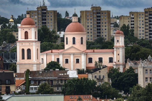 Church with red domes in front of modern residential buildings in Vilnius, Vilnius, Lithuania