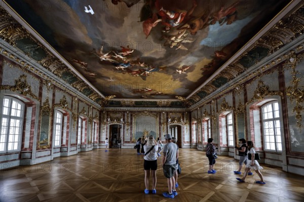 Baroque interior with detailed ceiling painting and visitors, Rundale, Latvia