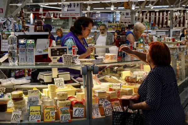 Market visitors shop at busy stands in Riga Central Market, Riga, Latvia