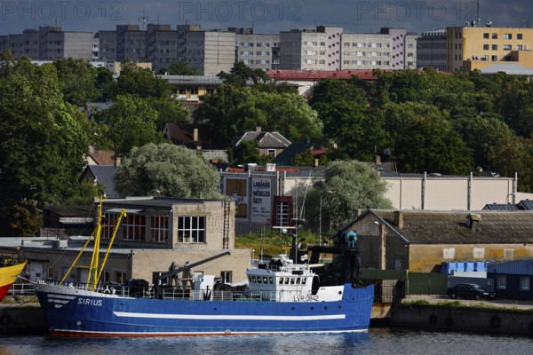 Fishing port with fishing boats and surrounding apartment blocks, Ventspils, Latvia