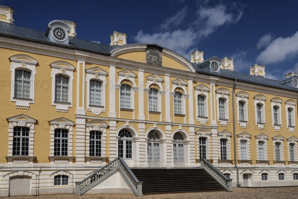Ruhenthal Castle with classic baroque façade under bright blue sky, Rundale, Latvia