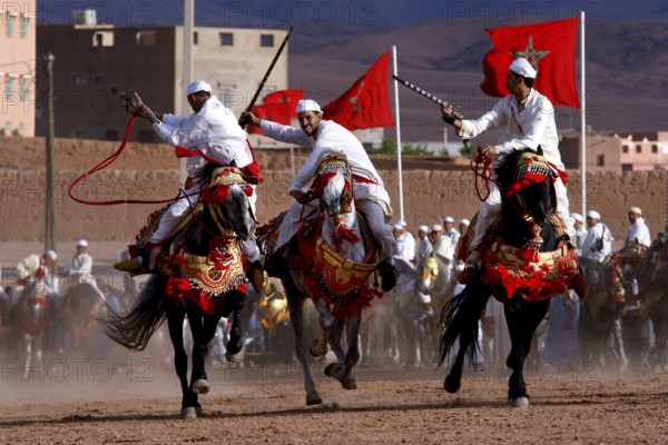 Riders in traditional clothing perform at Fantasia during the Fête des Roses, El Kelâa m'Gouna, Morocco