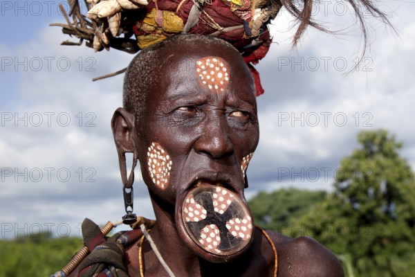 Mursi woman with lip plate and artistic face painting, Mago National Park, Ethiopia