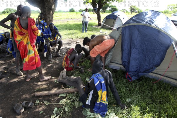 Mursi people in a tent camp under a tree, Mago National Park, Ethiopia