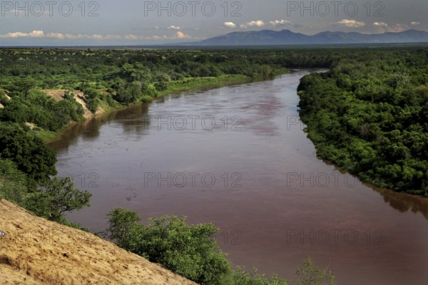 Wide Omo River amid green landscape with views of surrounding hills, Kara Korcno, region, Ethiopia