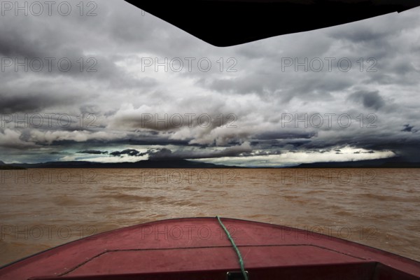 Threatening skies and gloomy waters on a boat trip across Lake Chamo, Nech Sar National Park, Ethiopia