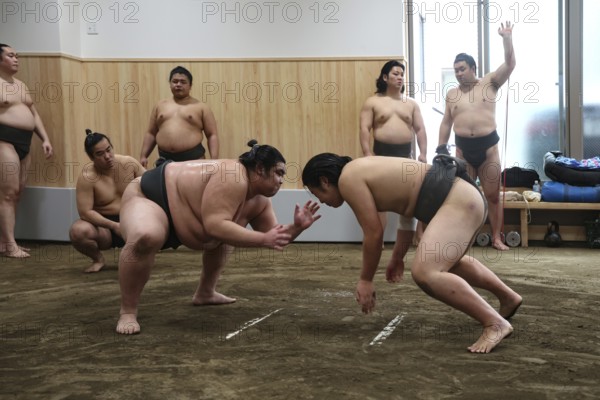 Two sumo wrestlers start training battle at Ryogoku Center, Tokyo, Ryogoku, Japan