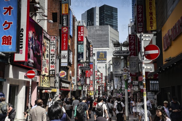 Busy street scene in Shibuya with lots of people and colorful advertisements, Tokyo, Tokyo, Japan