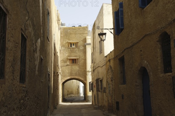 Shady alley with stone buildings and arched passageway, El Jadida, Cité Portugaise, Morocco