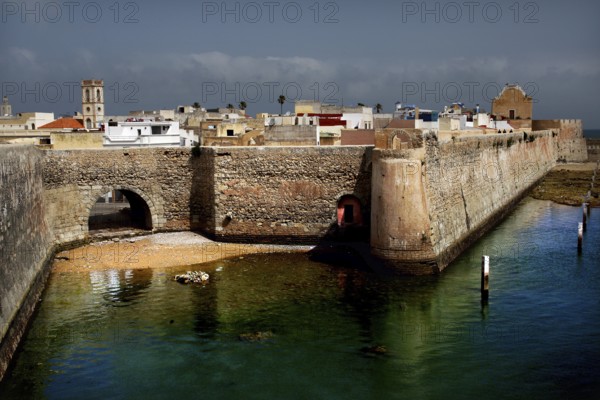 Towering fortress walls on the edge of a body of water, El Jadida, Cité Portugaise, Morocco