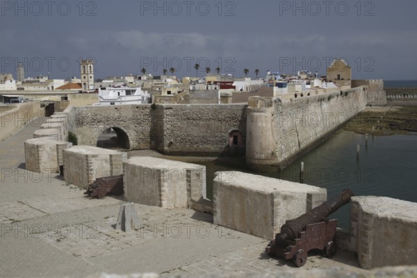 Massive fortress walls with cannons flanked by the sea, El Jadida, Cité Portugaise, Morocco