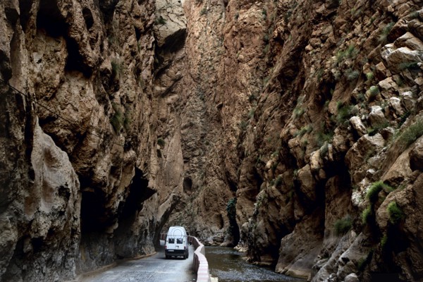 A white vehicle drives through the narrow section of Dadès Gorge, Dadès Gorge, Morocco