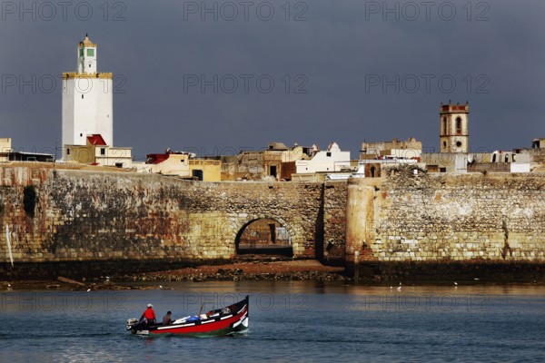 Historic seaside fortress with a small boat in the foreground, El Jadida, Cité Portugaise, Morocco