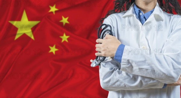 Healthcare professional with China flag background. Professional doctor holding stethoscope on China flag background
