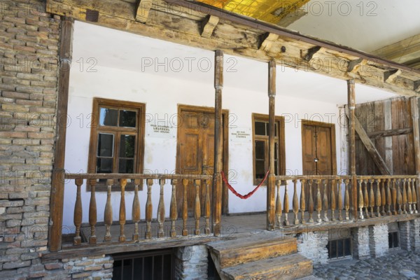 Rustic wooden veranda of a building with old wooden windows, birthplace of Josef Stalin, Gori, Inner-Kartli region, Georgia