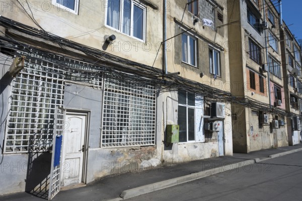 Multi-storey apartment block with lots of exposed cables and aged façade, Gori, Inner Kartli region, Georgia