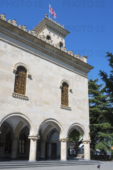Historic building with decorated façade and a flag against a blue sky, Josef Stalin Museum, Gori, Inner Kartli region, Georgia