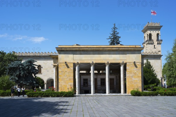 Historic building with columns and Georgian flag in clear blue sky, Josef Stalin Museum, Gori, Inner Kartli Region, Georgia