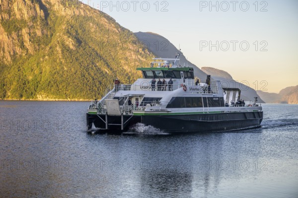 Large ferry operated by the Columbus shipping company sails through the Lysefjord with an impressive mountain panorama in the background, Lysefjord, Rogaland, Norway