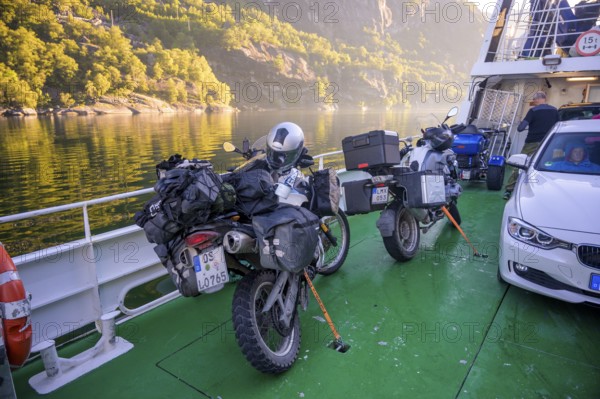 Motorbikes with luggage on a Kolumbsu shipping company ferry on the Lysefjord in sunny weather, Lysefjord, Rogaland, Norway