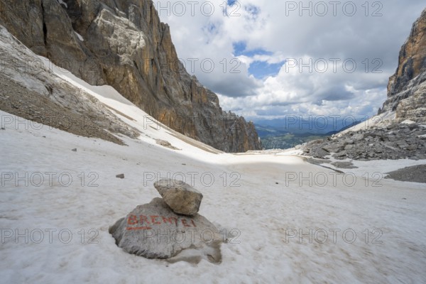 Guide to Rifugio Brentei on a rock, remains of the Vedretta dei Camosci glacier, Brenta Mountains, Brenta-Adamello Natural Park, Trentino, Italy