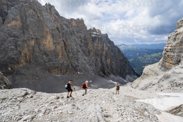 Three climbers descending the Sentiero Martinazzi, Camosci Valley, Brenta Mountains, Brenta-Adamello Natural Park, Trentino, Italy