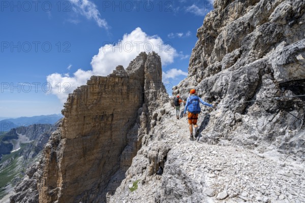 Two mountaineers on the Via Ferrata Brentari via ferrata, spectacular mountain landscape with steep rock faces, Brenta Mountains, Parco Naturale Brenta-Adamello, Trentino, Italy