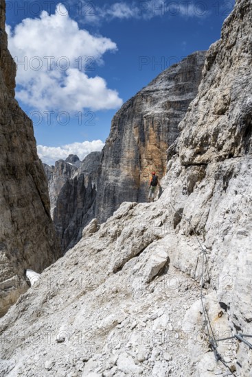 Climbers on the Via Ferrata Brentari via ferrata, spectacular mountain landscape with steep cliffs, Brenta Mountains, Parco Naturale Brenta-Adamello, Trentino, Italy