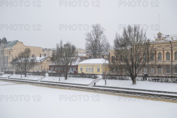 Pharmacy museum and other historic buildings on the frozen Aurajoki river, wintery Turku or Swedish Åbo, Varsinais-Suomi, Finland