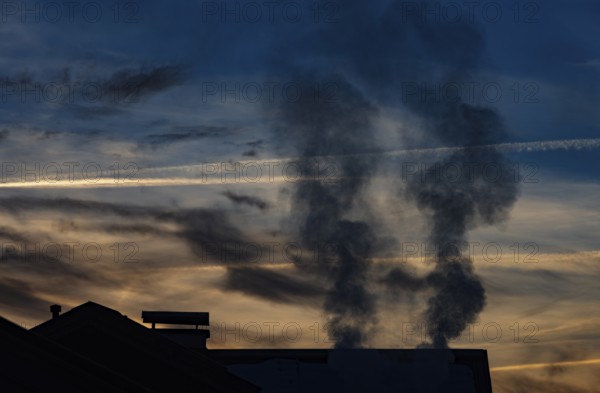 Smoking chimney of a residential building in winter, sunset, environmental pollution, Mondseeland, Salzkammergut, Upper Austria, Austria