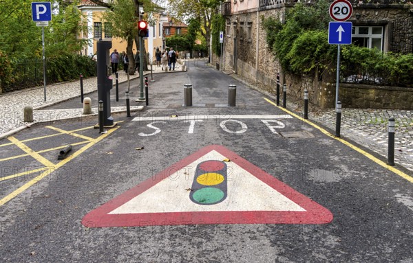 Traffic light and road signs on the asphalt, Sintra, Lisbon, Portugal