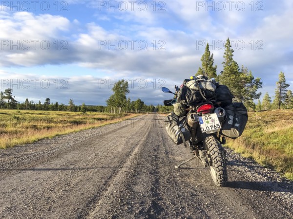 Idre, Dalarnas län, Sweden, BMW G 650 GS Sertao enduro motorcycle on a sunny road in the middle of a picturesque landscape