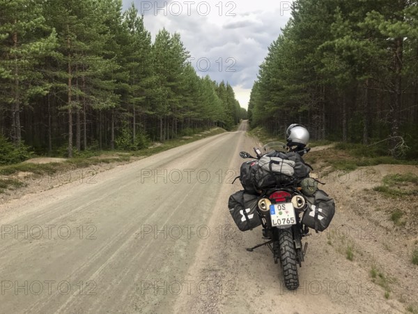 Torsby, Värmlands län, Sweden, BMW G 650 GS Sertao Enduro motorcycle stands on a secluded forest path surrounded by thick forest