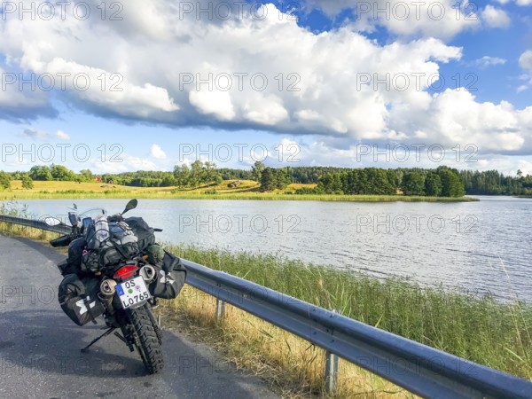 Sparreholm, Södermanlands län, Sweden, BMW G 650 GS Sertao Enduro motorcycle on a country road next to a lake under a cloudy sky