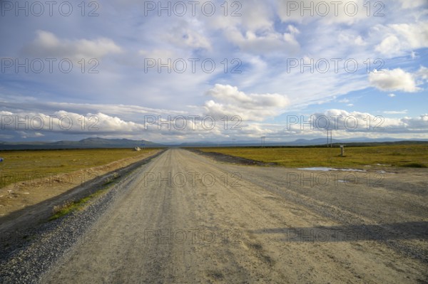 Falkvålen, Bruksvallarna, Jämtland, Sweden, long straight road in a wide landscape under a gently cloudy sky