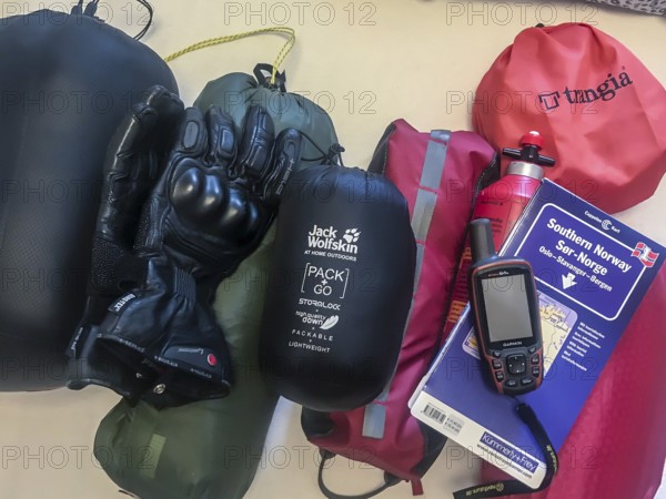 Bakum, Melle, Lower Saxony, Germany, camping equipment on a table with tent, stove, gloves and GPS device