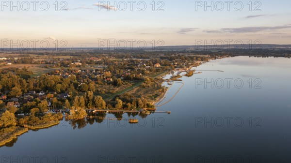 Lembruch, Lower Saxony, Germany, view of Lake Dümmer with adjacent weekend house settlements and harbours in the foreground and the outflow of the river Lohne at dusk, calm water with reflections, aerial view