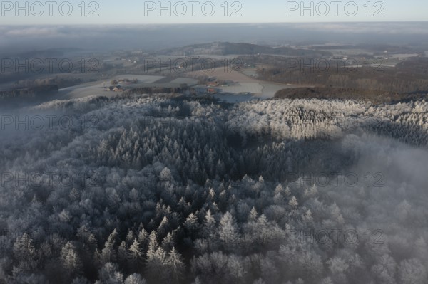 Borgholzhausen, North Rhine-Westphalia, Germany, aerial view of snow-covered Teutoburg Forest, partly surrounded by fog, wintery atmosphere