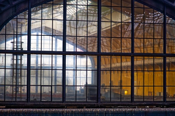 An industrial window front takes a look at the interior of an old station building