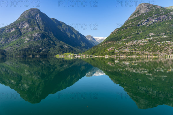 Tranquil mountain and lake landscape with clear, reflecting water surface