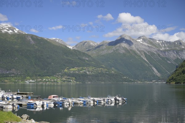 Norddal, Møre og Romsdal province, Norway, harbour with boats against a backdrop of high mountains and clear skies