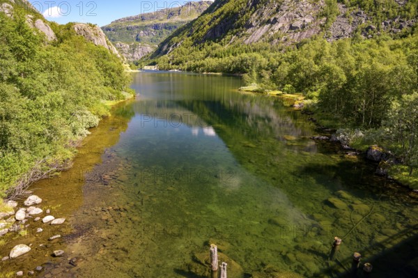 Røldal, Vestland, Norway, Idyllic lake with a clear reflection surrounded by green mountains in the fjords